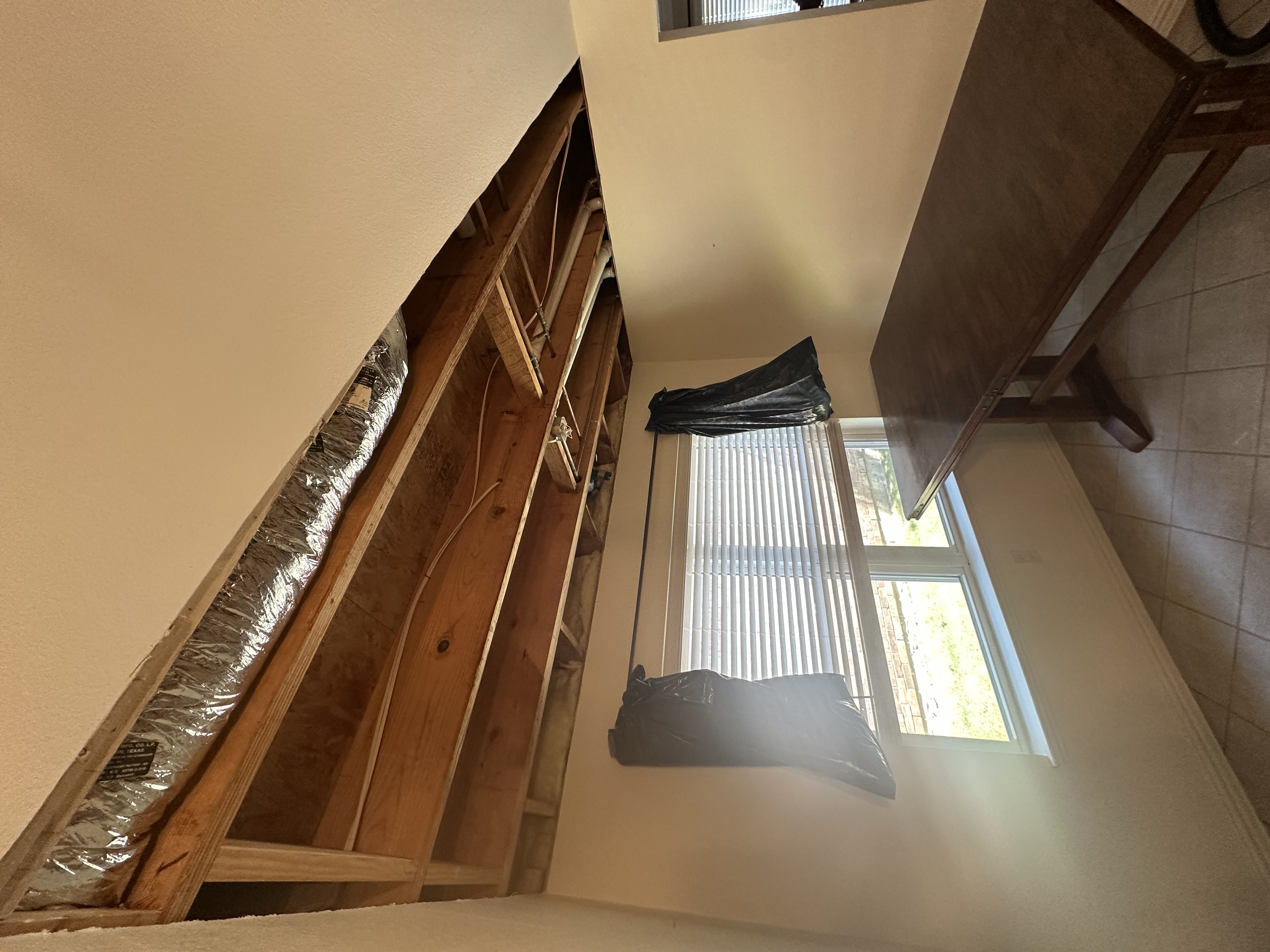 Wall opened exposing studs for renovation